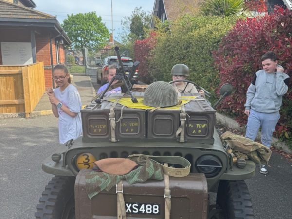 Learners at The Orchard, explore a military jeep as part of learning about VE Day